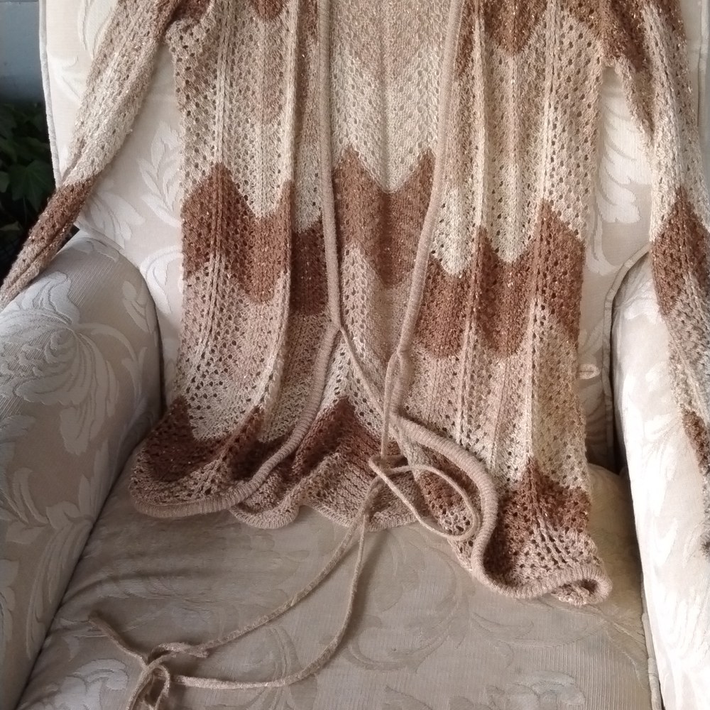 Different color Tans and brown long sweater kind of like a cardigan it ties in t
